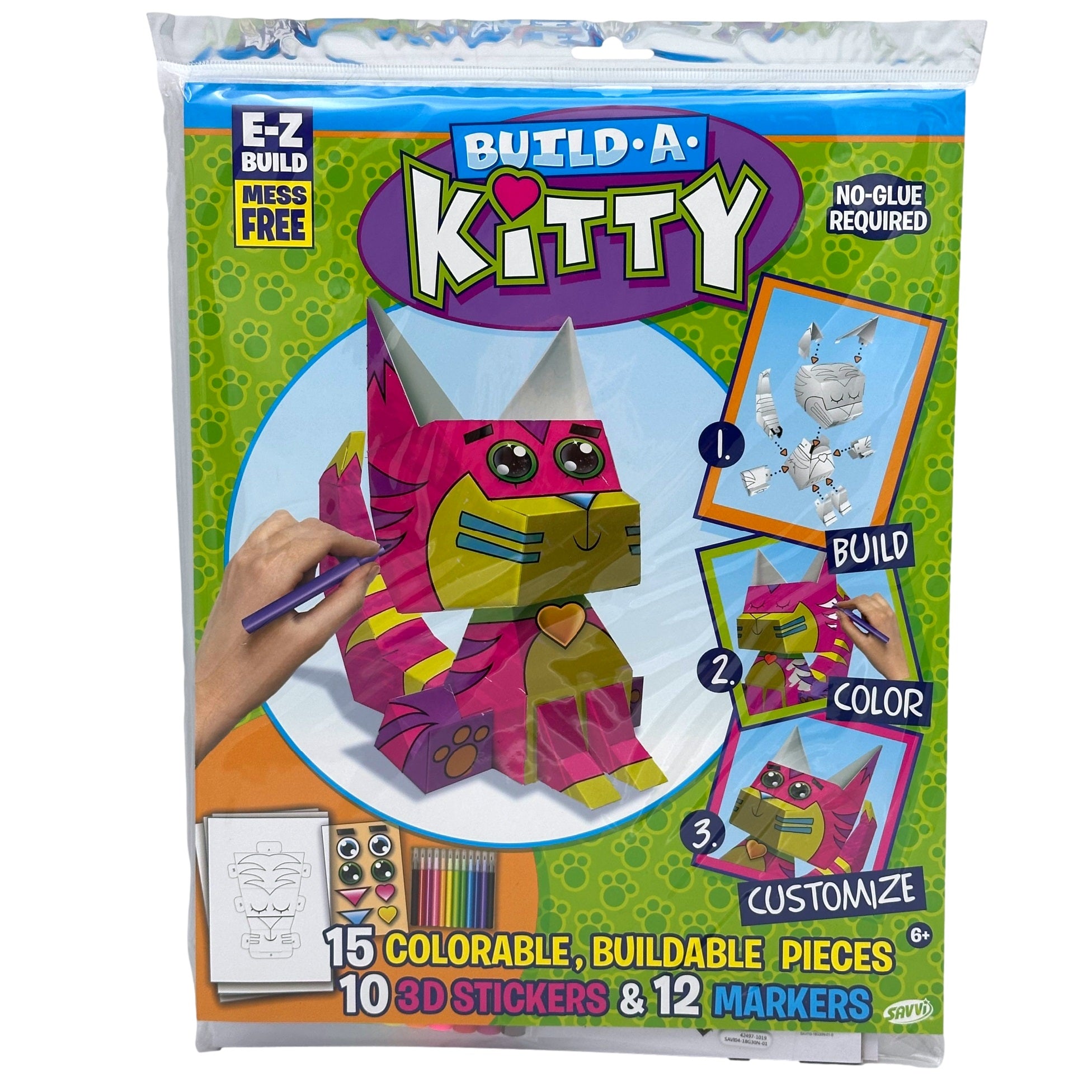 Close-up of a "Build-A-Kitty" craft kit in a clear plastic bag. The packaging features a colorful, cartoon-style image of a buildable cat, as well as instructions for building, coloring, and customizing. The kit includes 15 colorable pieces, 10 3D stickers, and 12 markers.